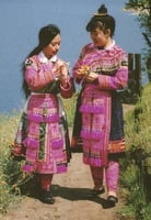 Color scan of a Hmong New Year postcard showing two young women in traditional Hmong dress, c.1980s.